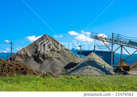 A blue sky and a mountain of stones 25479562
