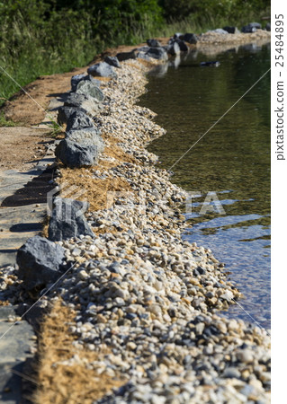Rocks on bank of natural swimming pond or pool NSP Rocks on bank of natural swimming pond or pool NSP 25484895