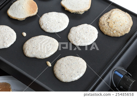 Oat pancakes cooking on electric barbecue Oat pancakes cooking on electric barbecue 25485658