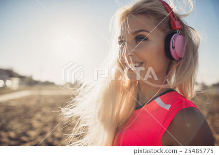 Portrait of young beautiful woman listening to Portrait of young beautiful woman listening to 25485775