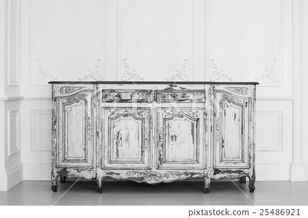Ancient white commode bureau with paint peeled off 25486921