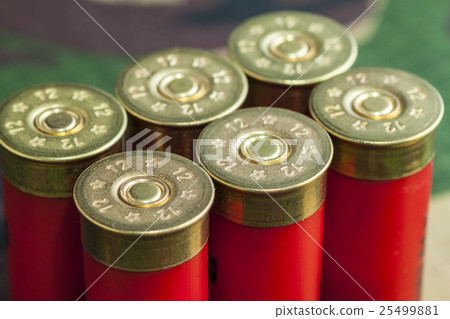 Old hunting cartridges on camouflage background 25499881