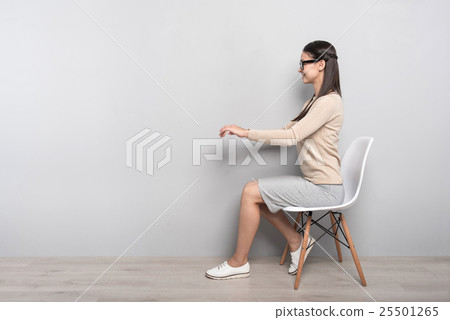 Positive woman sitting in the chair Positive woman sitting in the chair 25501265