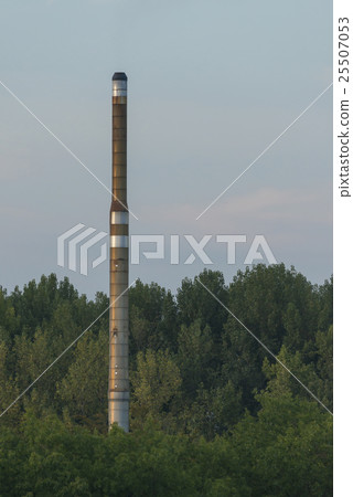 Factory chimney in a green environment. 25507053