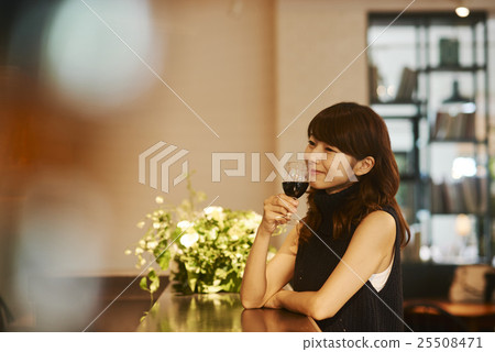 A woman drinking wine 25508471