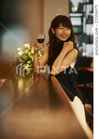 A woman drinking wine 25508475