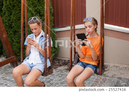 Teenagers with gadgets Teenagers with gadgets 25527416