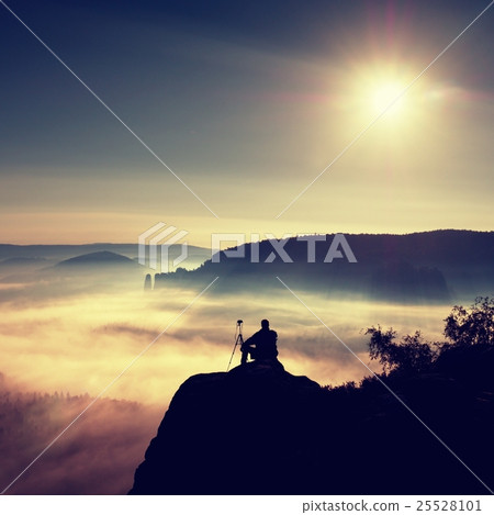 Photographer thinking. Dreamy fogy landscape 25528101