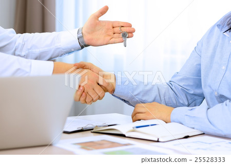 Real-estate agent signing a contract. Handshake Real-estate agent signing a contract. Handshake 25528333