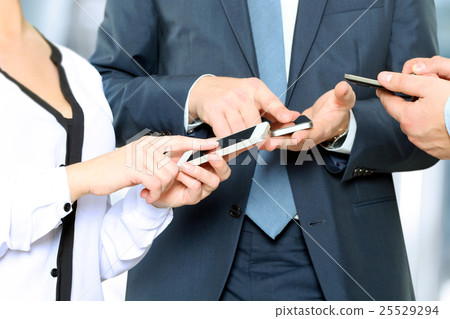 Business men and woman using mobile smart phones Business men and woman using mobile smart phones 25529294