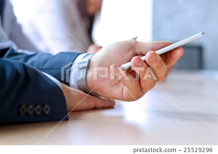 Businessman holding/using  the mobile smart phone 25529296