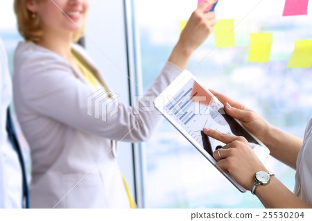 business team working in office with stickers business team working in office with stickers 25530204