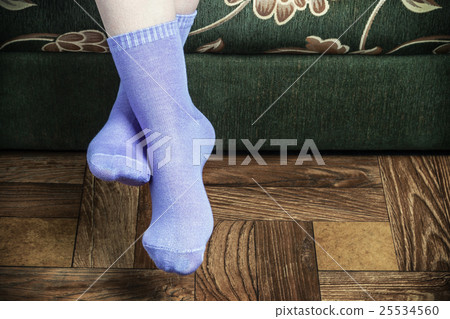 legs overhang from the sofa in purple socks legs overhang from the sofa in purple socks 25534560