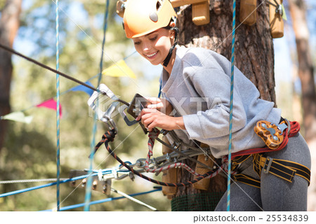 Pretty joyful woman fastening the carabiner 25534839