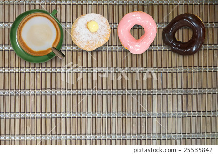 Cappuccino coffee donut on bamboo background Cappuccino coffee donut on bamboo background 25535842