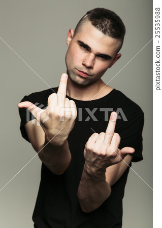 Man in black t-shirt showing middle fingers 25535988