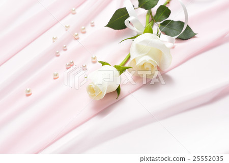Flowers tied with ribbon on pink cloth  25552035