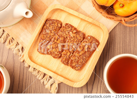 Chocolate crunch and tea cup served on the table Chocolate crunch and tea cup served on the table 25554843