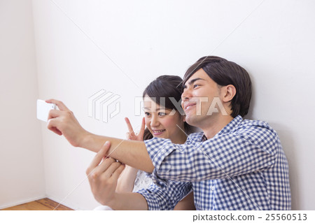 Male and female sitting side by side 25560513