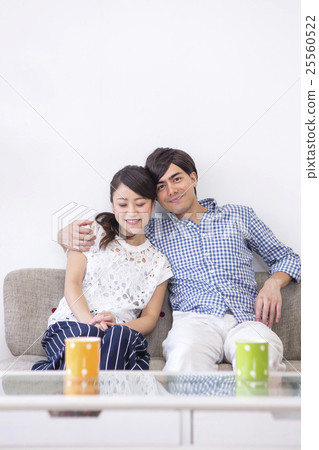 Male and female sitting side by side Male and female sitting side by side 25560522