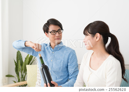 A couple enjoying wine A couple enjoying wine 25562628