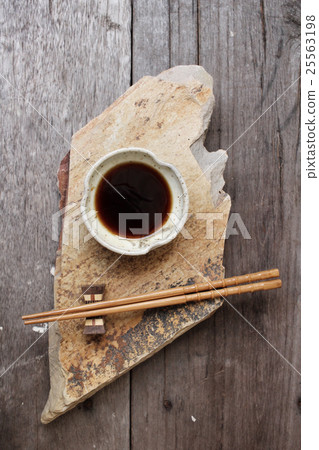 Soy sauce with chopsticks 25563198