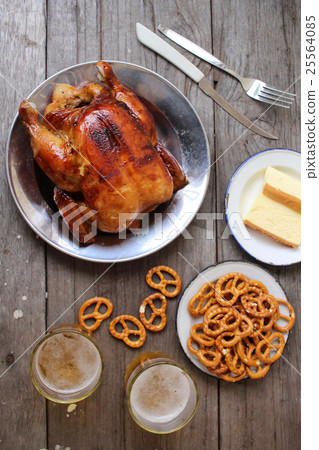 Chicken roasted and pretzels with beer in party Chicken roasted and pretzels with beer in party 25564085