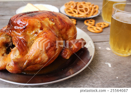 Chicken roasted and pretzels with beer in party Chicken roasted and pretzels with beer in party 25564087