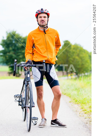 Sport Cyclist with bike having break Sport Cyclist with bike having break 25564207