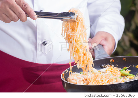 Chef fork over noodles by tongs Chef fork over noodles by tongs 25565360
