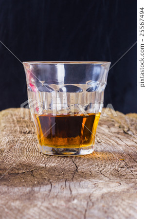 a glass of brandy on a wooden background with spac a glass of brandy on a wooden background with spac 25567494