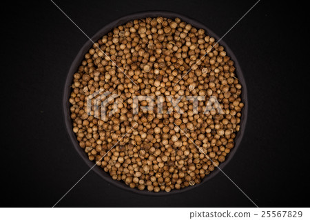 Coriander seeds in  small bowl 25567829