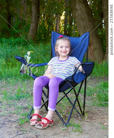 girl child sit on chair in forest at family picnic girl child sit on chair in forest at family picnic 25568698
