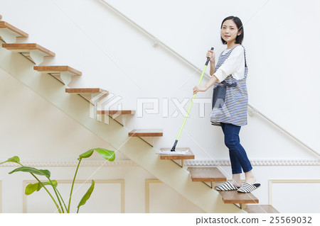 A woman using a stairway floor wiper A woman using a stairway floor wiper 25569032