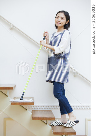 A woman using a stairway floor wiper A woman using a stairway floor wiper 25569039