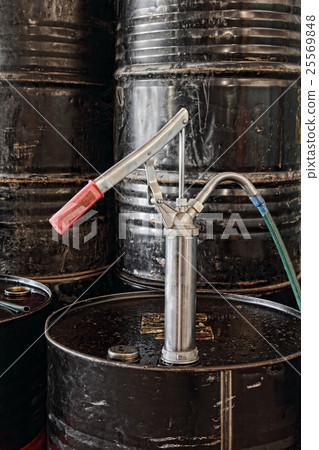 Manual pump topped on black oil flank. Manual pump topped on black oil flank. 25569848