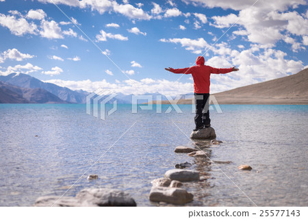 Traveler standing on the rock at Pangong Lake Traveler standing on the rock at Pangong Lake 25577143