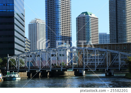 Truss bridge over river and high rise apartment group 25582201