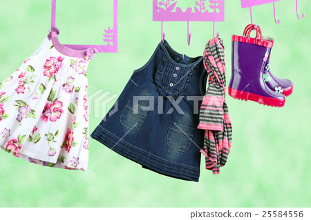 Fashion baby dresses hanging on a hanger  25584556