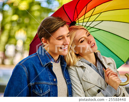 Couple in love on date under umbrella after rain. Couple in love on date under umbrella after rain. 25588448
