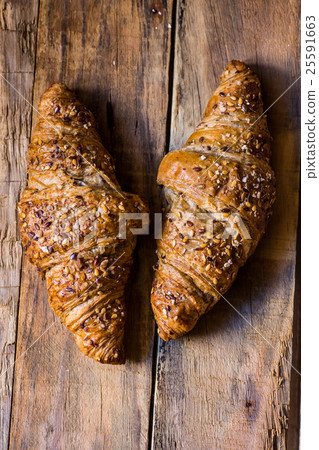 croissants with sesame seeds on wood top view 25591663