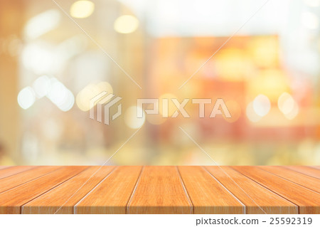 Wooden board empty table blur in coffee shop Wooden board empty table blur in coffee shop 25592319