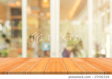 Wooden board empty table blur in coffee shop Wooden board empty table blur in coffee shop 25592320