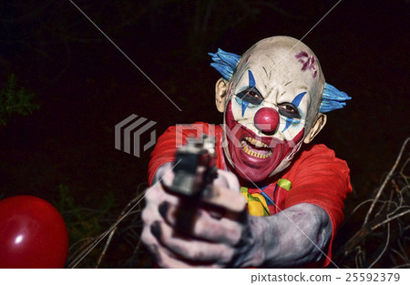 scary evil clown with a gun 25592379