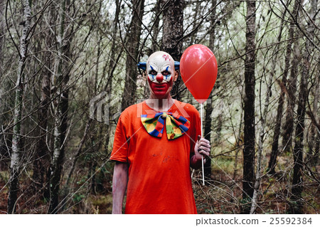 scary evil clown in the woods 25592384