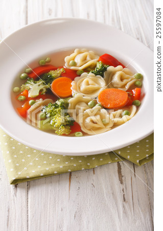 Hot tortellini soup with broccoli, peas, carrot 25597084