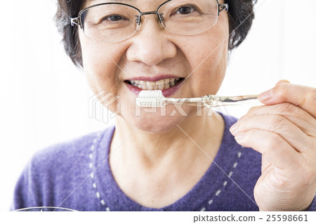Senior woman brushing teeth Senior woman brushing teeth 25598661