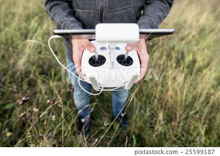 Unrecognizable man with remote control. Sunny Unrecognizable man with remote control. Sunny 25599187