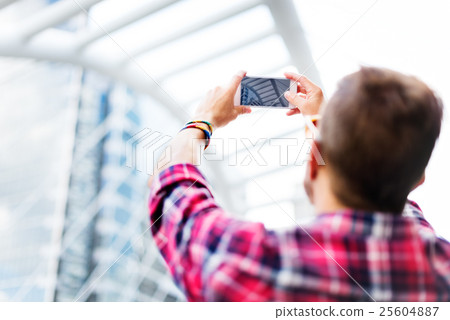 Young Man Taking Photo Smartphone Concept 25604887