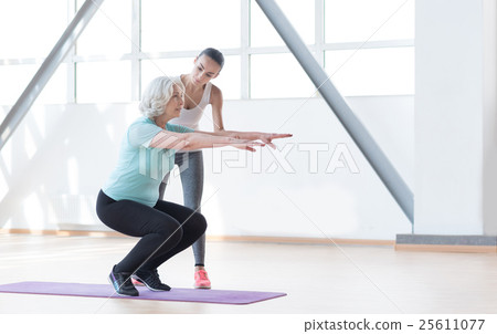 Hard working persistent woman squatting Hard working persistent woman squatting 25611077